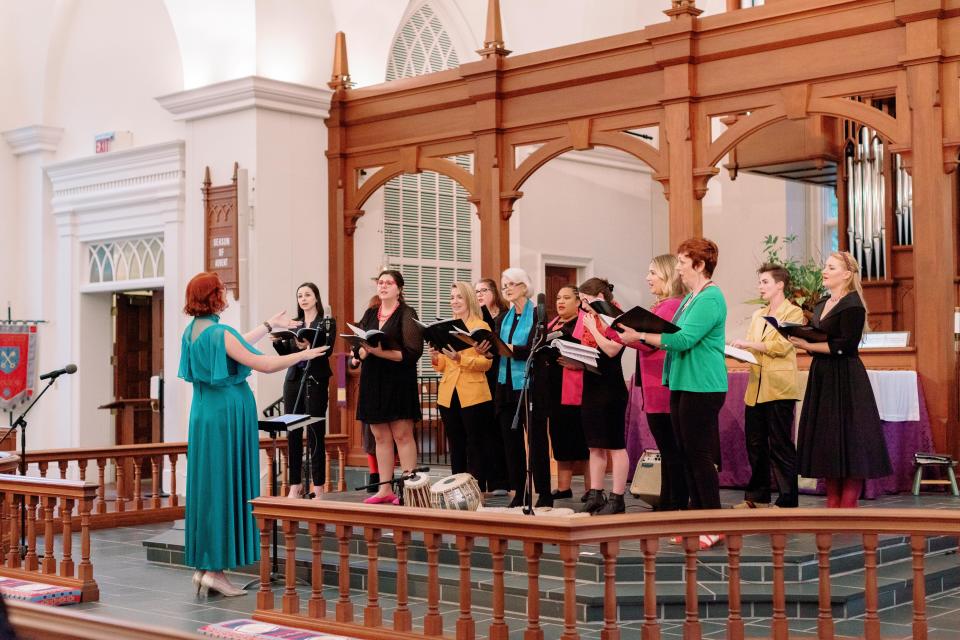 The all-female Spectra Choir performs.