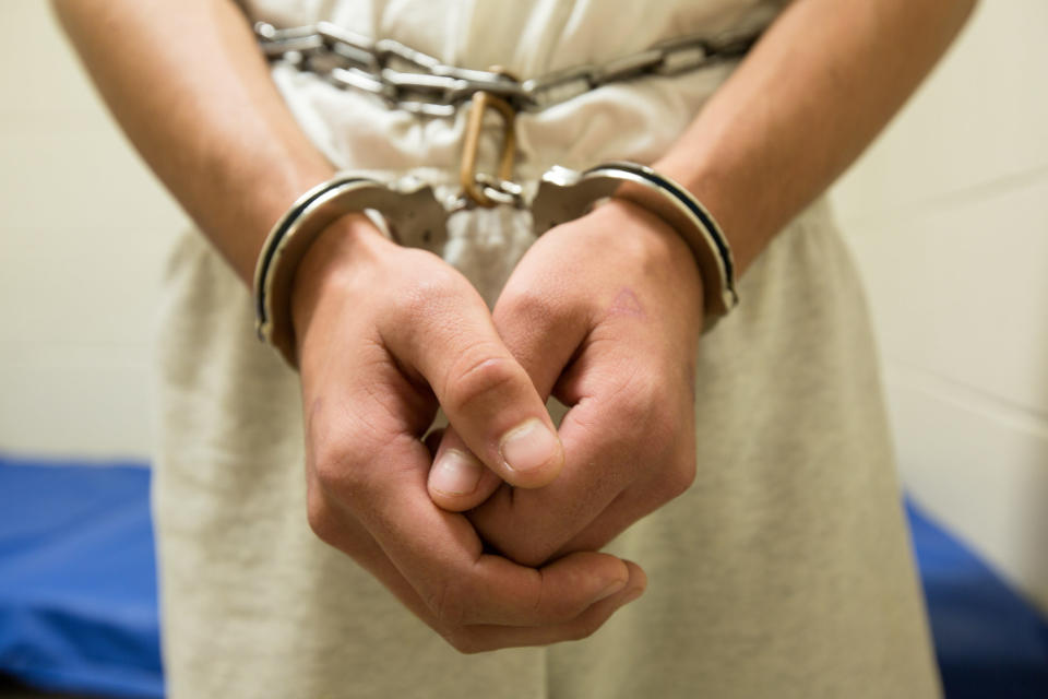 A person's hands in handcuffs