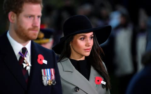 Prince Harry, who has served in the Army, with Meghan Markle during the poignant event in London - Credit: Toby Melville /PA