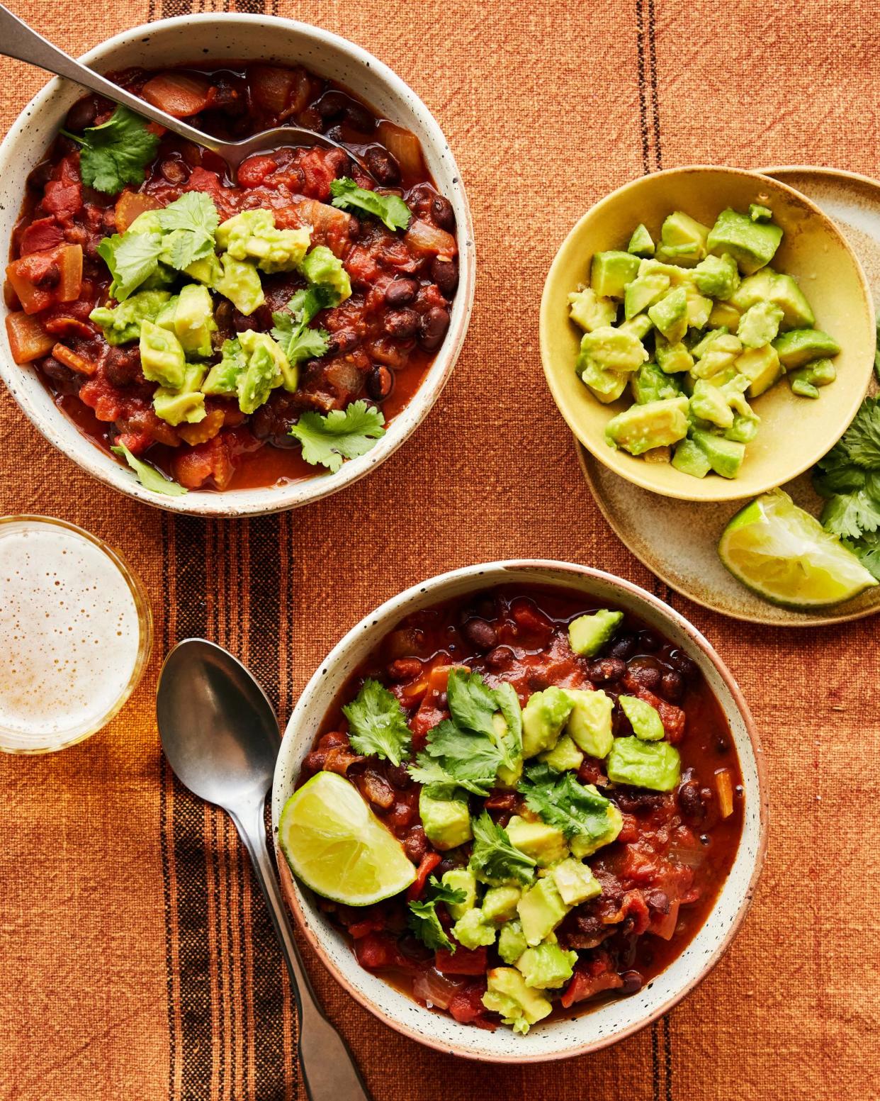 <span>Rukmini Iyer’s spiced black bean and tomato soup with avocado and lime.</span><span>Photograph: Matthew Hague/The Guardian. Food and prop styling: Lucy Turnbull. Food styling assistant: Katie Smith.</span>