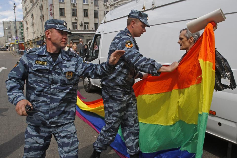 FILE - Russian police officers detain a gay rights activist with his flag during an attempt to hold a gay pride parade in Moscow, Russia, on May 27, 2012. Russian lawmakers on Wednesday June 14, 2023 approved in first reading a bill outlawing gender-affirming medical care and changing gender in official documents in yet another crippling blow to Russia's already beleaguered LGBTQ+ community. (AP Photo, File)