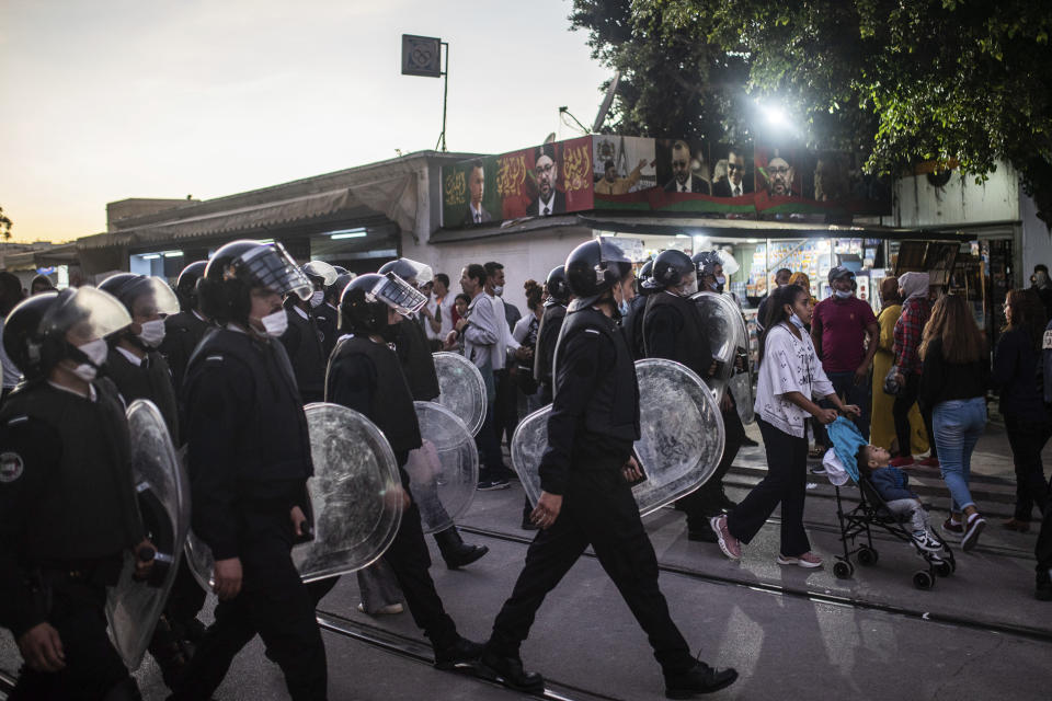 Security forces disperse a protest against the government enforcing of a mandatory COVID-19 vaccine pass, in Rabat, Morocco, Sunday, Oct. 31, 2021. (AP Photo/Mosa'ab Elshamy)