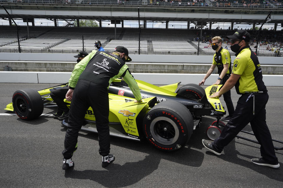 Charlie Kimball, left, touches his car after failing to qualify for the Indianapolis 500 auto race at Indianapolis Motor Speedway, Sunday, May 23, 2021, in Indianapolis. (AP Photo/Darron Cummings)