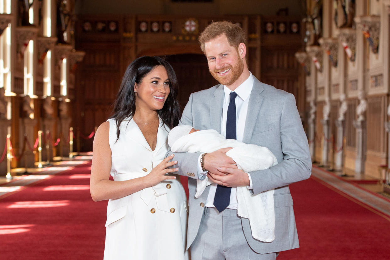 Britain's Prince Harry and Meghan, Duchess of Sussex are seen with their baby son, who was born on Monday morning, during a photocall in St George's Hall at Windsor Castle, in Berkshire, Britain May 8, 2019. Dominic Lipinski/Pool via REUTERS