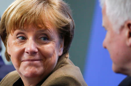 German Chancellor Angela Merkel smiles to Bavarian state premier and leader of the Christian Social Union (CSU) Horst Seehofer (R) during a news conference at the Chancellery in Berlin, Germany, April 14, 2016. REUTERS/Fabrizio Bensch/File Photo