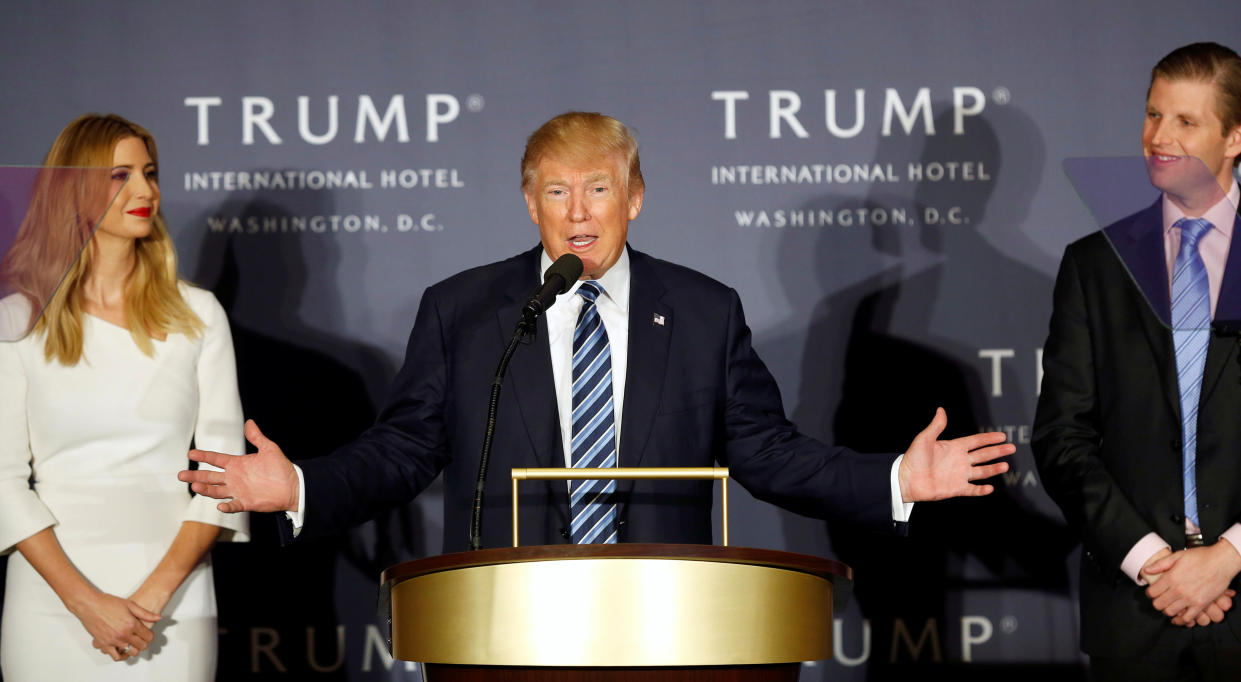 Republican U.S. presidential nominee Donald Trump (C) speaks at an official ribbon cutting ceremony and opening news conference next to his daughter Ivanka (L) and son Eric (R) at the new Trump International Hotel in Washington U.S., October 26, 2016.  REUTERS/Gary Cameron