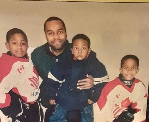 Gary Smith poses with his three sons, from left: Gary Smith Jr., Red Wings forward Givani Smith and Gemel Smith.