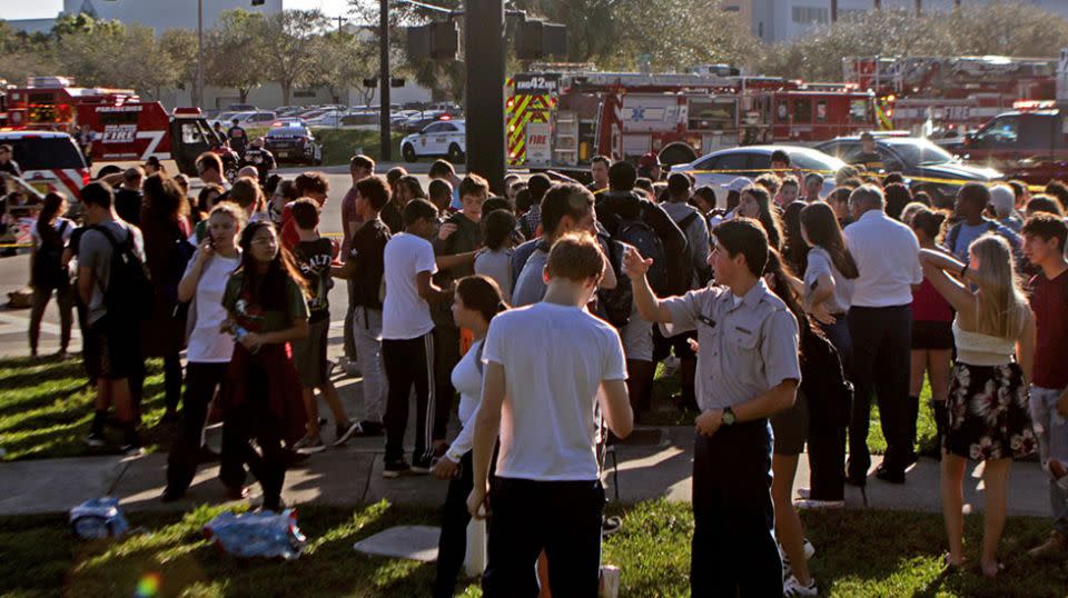 Students gather outside the school after the suspect was taken into custody. Source: Getty