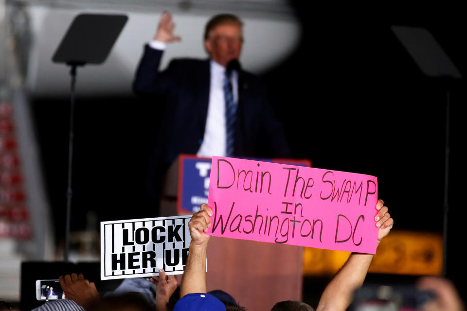 A man holds up a “Drain the Swamp in Washington DC” sign as Republican presidential nominee Donald Trump attends a campaign event at the airport in Kinston, N.C., Oct. 26, 2016. (Photo: Carlo Allegri/Reuters)