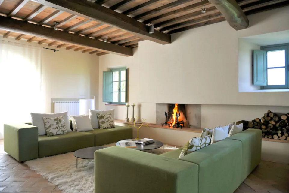 <p>Here you can see the traditional beamed ceilings with the modern decor. It also boasts three fireplaces. (Airbnb) </p>