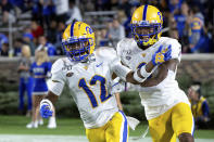 FILE - In this Oct. 5, 2019, file photo, Pittsburgh's Paris Ford (12) celebrates with Damar Hamlin after Ford scored a touchdown after an interception during the first half of an NCAA college football game against Duke, in Durham, N.C. Ford was selected to The Associated Press All-Atlantic Coast Conference football team, Tuesday, Dec. 10, 2019. (AP Photo/Ben McKeown, File)