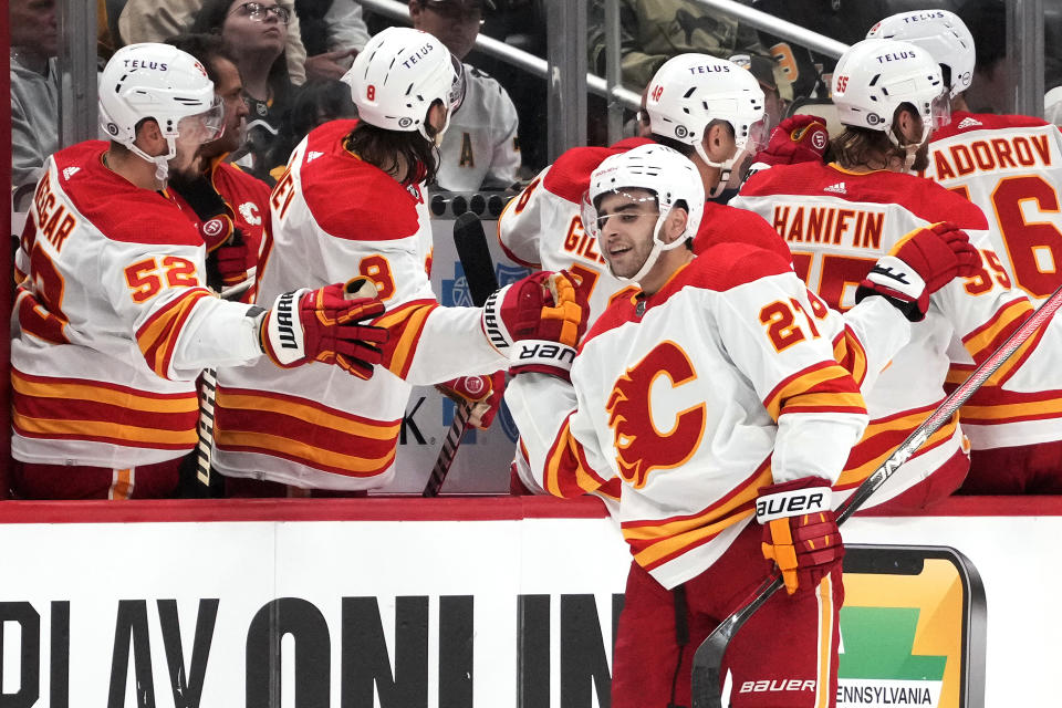 Calgary Flames' Matt Coronato (27) is congratulated for his goal against the Pittsburgh Penguins during the second period of an NHL hockey game in Pittsburgh, Saturday, Oct. 14, 2023. (AP Photo/Gene J. Puskar)