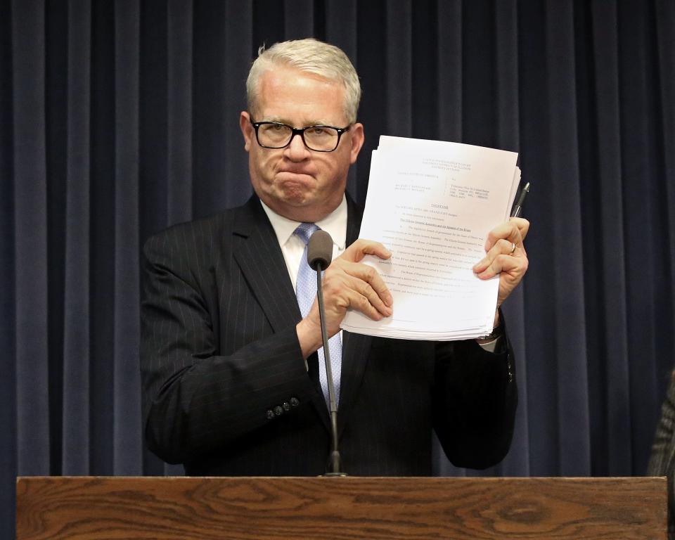 House Republican Leader Jim Durkin R-Western Springs holds up a printed copy of the Michael Madigan Indictment during a press conference at the State Capital Wednesday March 2, 2022. [Thomas J. Turney/ The State Journal-Register.