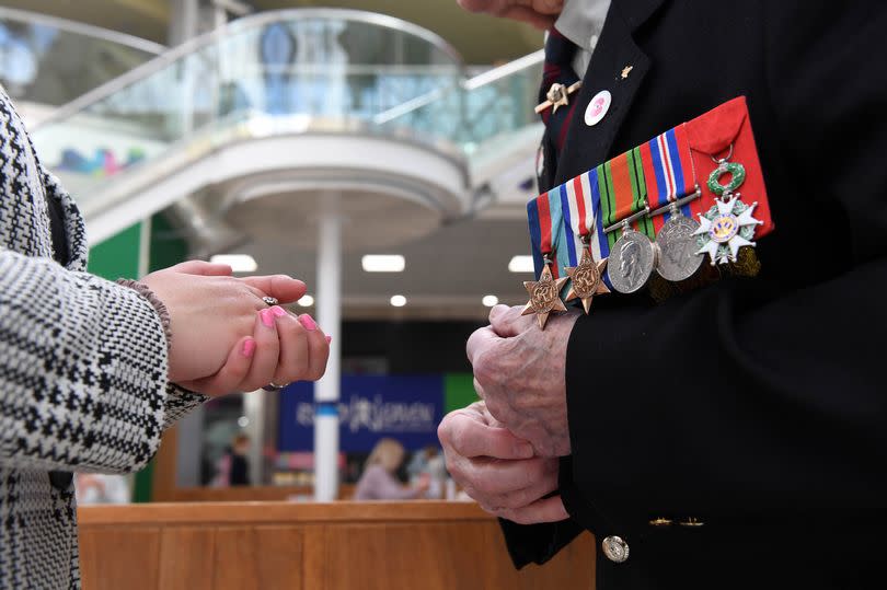 Cpl Pelzer spoke to WalesOnline about his experiences at the D Day landings [pictured: Molly Dowrick's hands and Cpl Pelzer's hands and medals!]