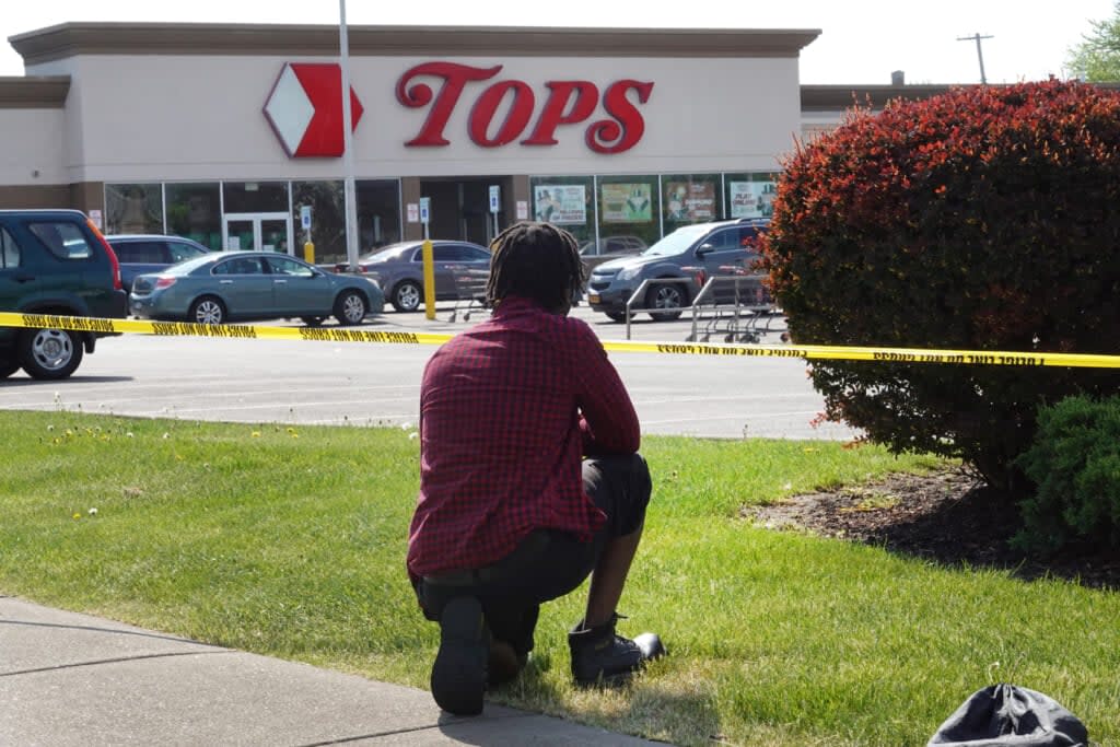 People gather outside of Tops market on May 15, 2022 in Buffalo, New York. On Saturday, a gunman opened fire at the store, killing 10 people and wounding another three. (Photo by Scott Olson/Getty Images)