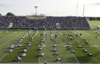 Minnesota Vikings players stretch on the field during an NFL football training camp practice, Monday, July 28, 2014, in Mankato, Minn. (AP Photo/Charlie Neibergall)