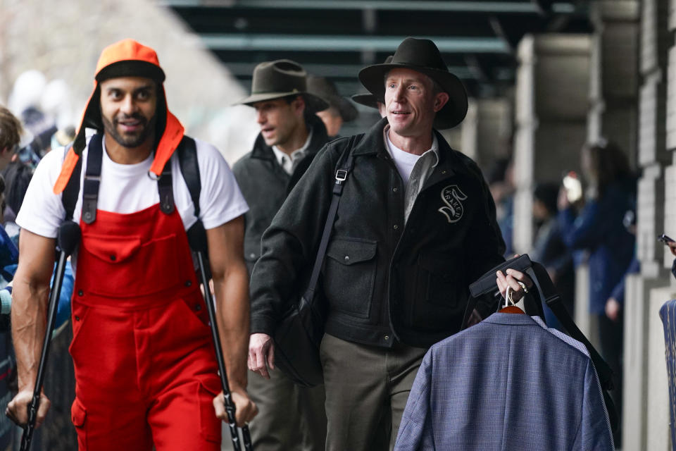 Seattle Kraken head coach Dave Hakstol, right, arrives with left wing Pierre-Edouard Bellemare, left, before the NHL Winter Classic hockey game against the Vegas Golden Knights, Monday, Jan. 1, 2024, in Seattle. (AP Photo/Lindsey Wasson)