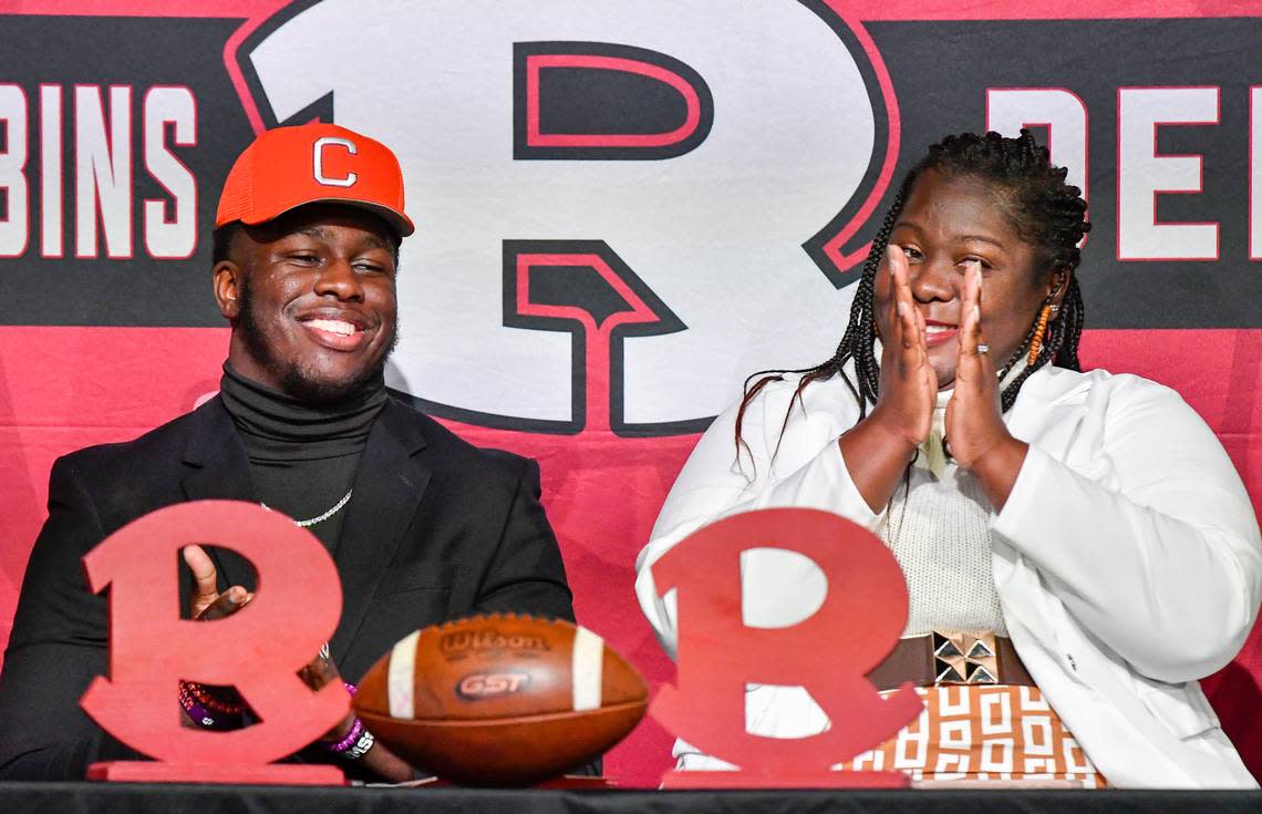 Warner Robins senior defensive end Vic Burley cracks a smile as his mother Heather Burley applauds after signing his National Letter of Intent with Clemson in the school’s auditorium Wednesday morning. Jason Vorhees/The Telegraph