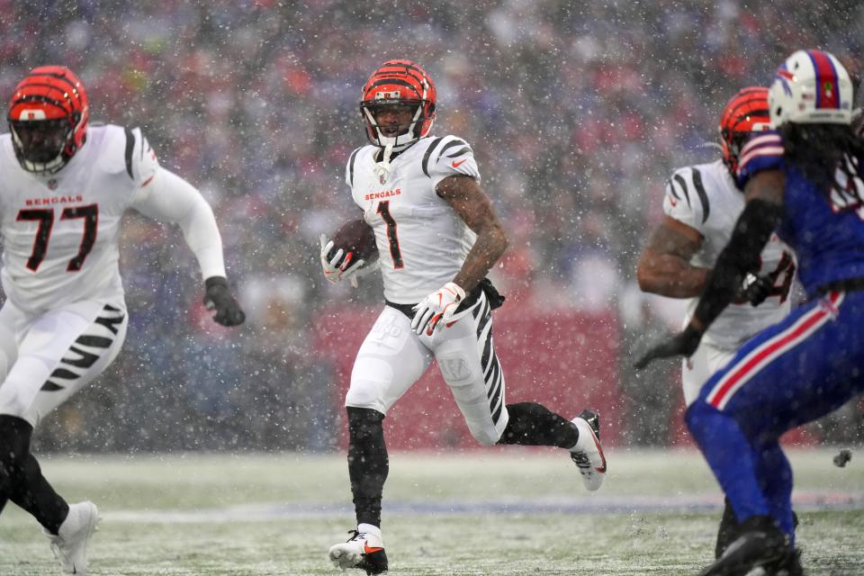 Cincinnati Bengals wide receiver Ja'Marr Chase (1) carries the ball in the first quarter during Sunday's game against the Buffalo Bills.