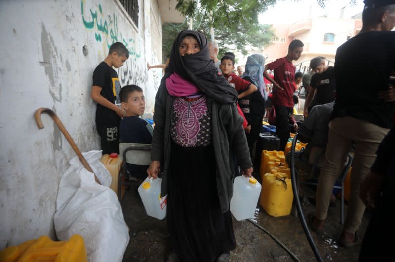 Palestinian civilians collect water using plastic jerrycans, donkey drawn carts and other forms of transport, in Rafah in the southern Gaza Strip on Saturday. Photo by Ismael Mohamad/UPI.