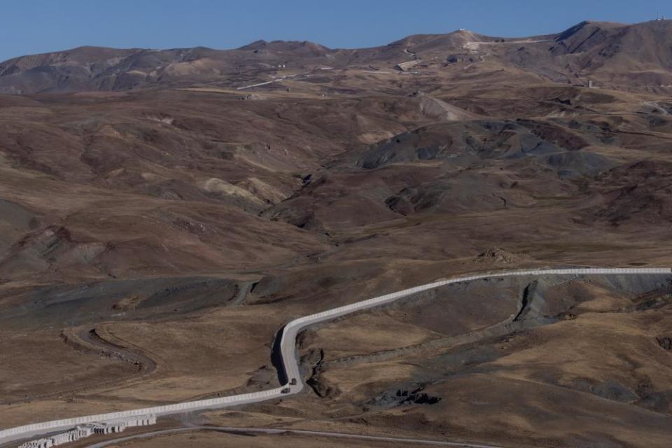 Turkish military vehicles patrol along a section of the Iran-Turkey border wall