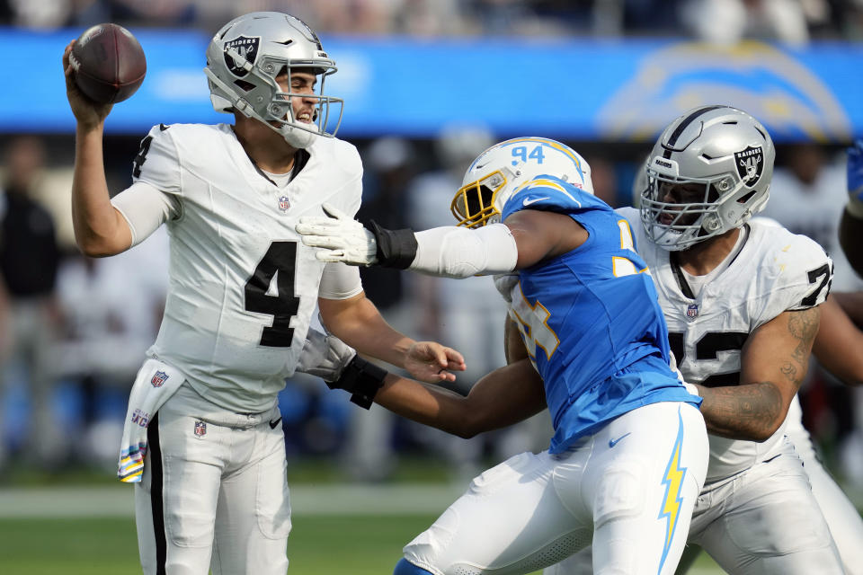 Las Vegas Raiders quarterback Aidan O'Connell (4) throws under pressure from Los Angeles Chargers linebacker Chris Rumph II (94) during the second half of an NFL football game Sunday, Oct. 1, 2023, in Inglewood, Calif. (AP Photo/Ashley Landis)