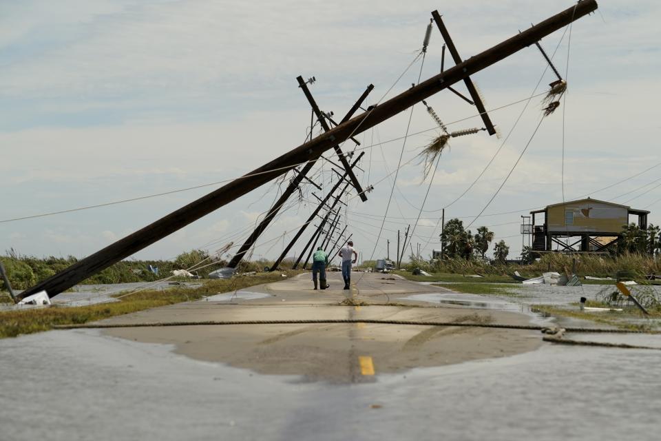 People survey the damage left in the wake of Hurricane Laura Thursday, Aug. 27, 2020, in Holly Beach, La. (AP Photo/Eric Gay)