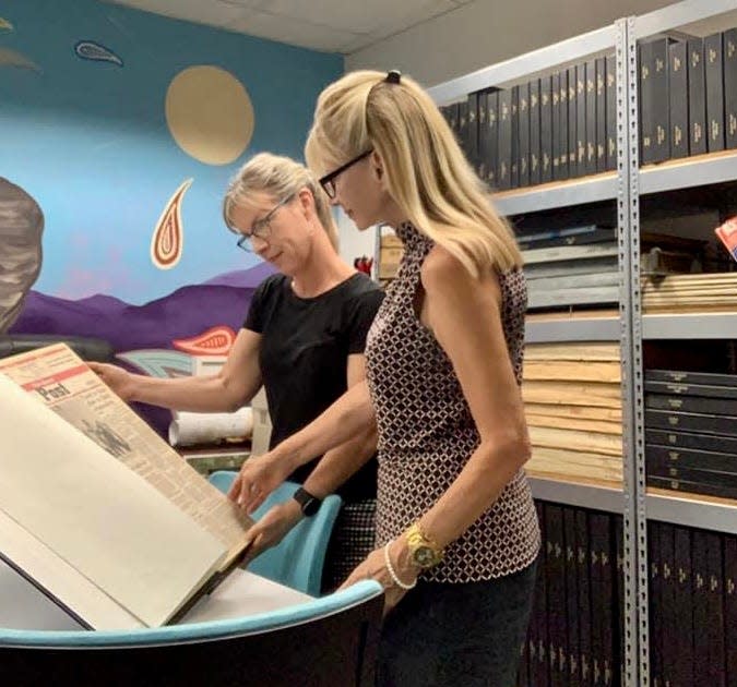 Sandie Newton and Desert Sun Executive Editor Julie Makinen looking at Desert Sun archives.