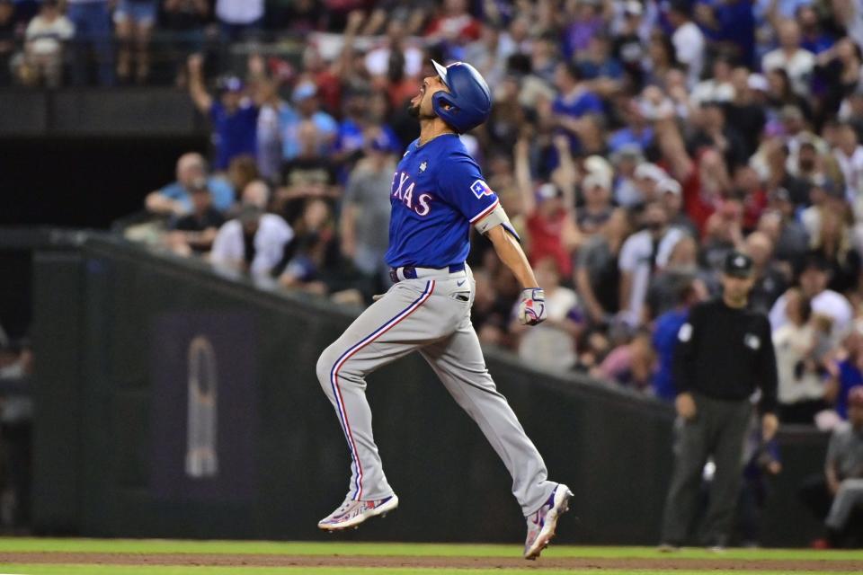 Rangers second baseman Marcus Semien rounds the bases screaming after hitting a two-run homer in the ninth inning.