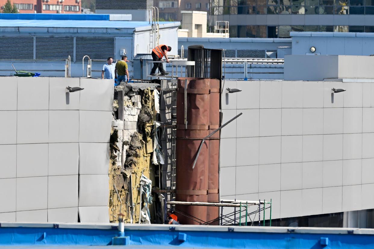 Investigators work at the site of a damaged exhibition hall at a business district after a reported drone attack in Moscow, Russia, Friday, Aug. 18, 2023. (AP Photo)