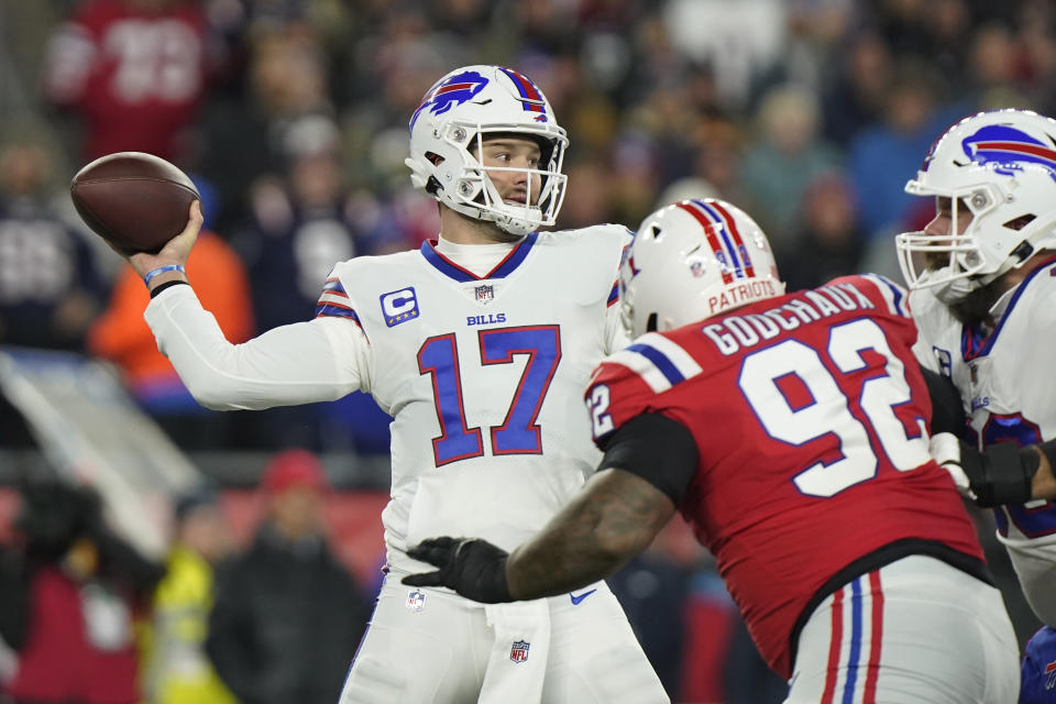 Buffalo Bills quarterback Josh Allen (17) throws under pressure from New England Patriots defensive tackle Davon Godchaux (92) during the first half of an NFL football game, Thursday, Dec. 1, 2022, in Foxborough, Mass. (AP Photo/Steven Senne)