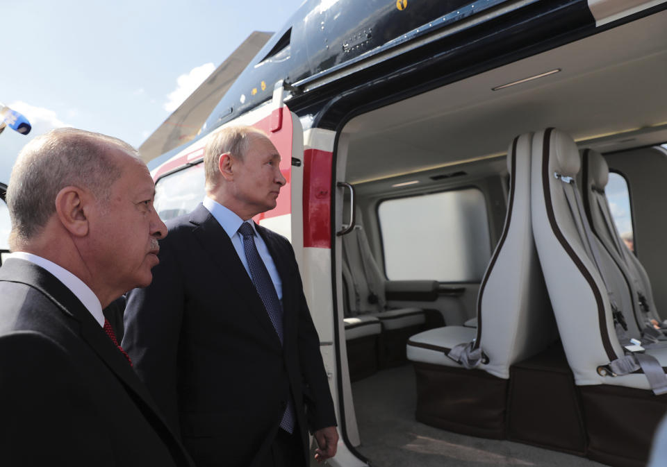 Turkey's President Recep Tayyip Erdogan, left, and Russia's President Vladimir Putin, centre, inspect a helicopter during the MAKS-2019 International Aviation and Space Show in Zhukovsky, outside Moscow, Russia, Tuesday, Aug. 27, 2019. Erdogan is on a short working visit in Russia.(Presidential Press Service via AP, Pool)