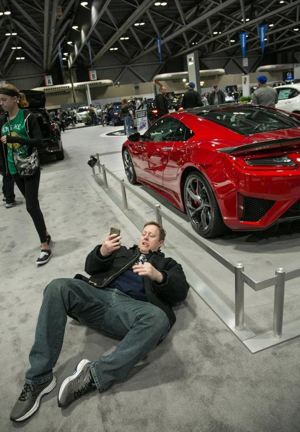 John O’Hara of Shawnee went the extra mile to get the right angle for his selfie with a 2017 Acura NSX on Saturday at the Greater Kansas City International Auto Show at Bartle Hall. The show continues Sunday from 10 a.m. to 6 p.m.