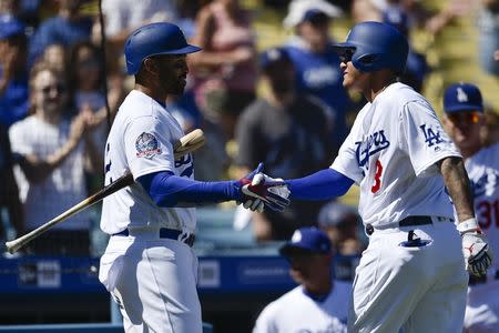 Sep 23, 2018; Los Angeles, CA, USA; Los Angeles Dodgers shortstop Manny Machado (right) celebrates with right fielder Matt Kemp (left) after hitting a solo home run during the second inning against the San Diego Padres at Dodger Stadium. Mandatory Credit: Kelvin Kuo-USA TODAY Sports