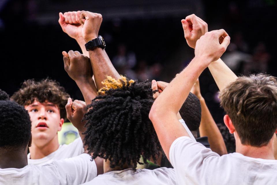 Central teammates hold up their hands in a huddle during the MSHSAA Class 6 semifinal against Cardinal Ritter at Mizzou Arena on Mar. 15, 2024, in Columbia, Mo.