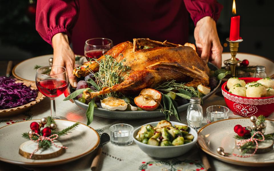 Woman setting the table for Christmas dinner