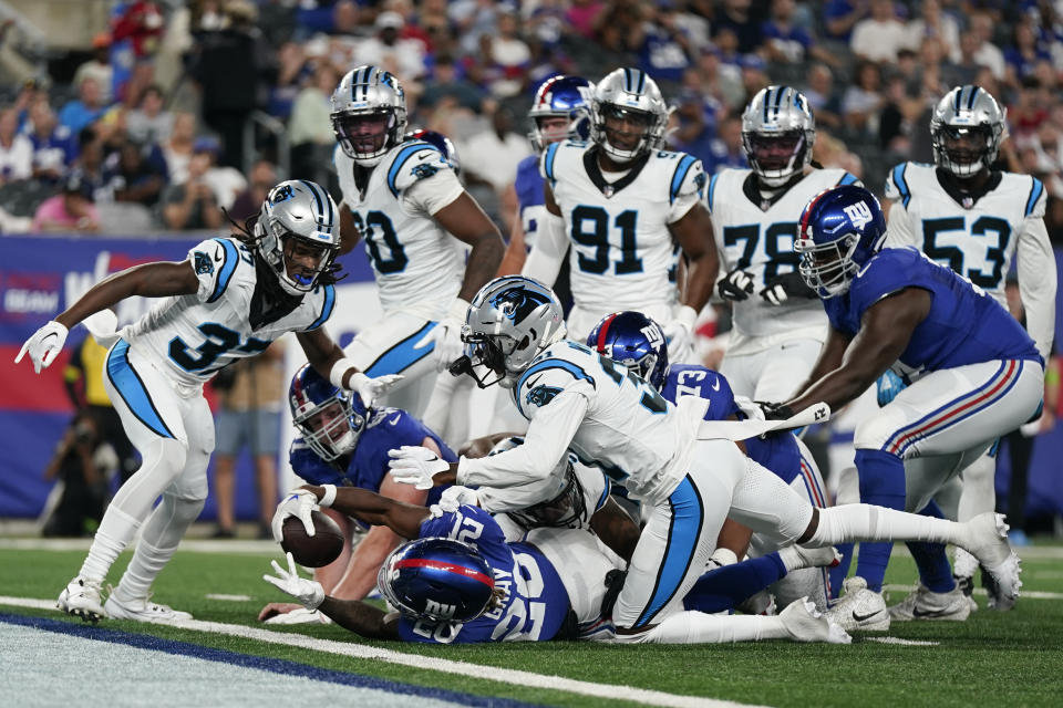 New York Giants' Eric Gray (20), bottom center, scores a touchdown during the first half of an NFL preseason football game against the Carolina Panthers, Friday, Aug. 18, 2023, in East Rutherford, N.J. (AP Photo/Bryan Woolston)