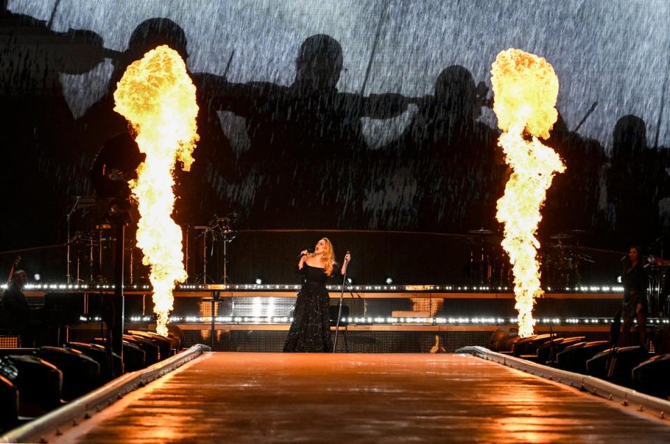 Adele gave a rousing performance of Set Fire To The Rain complete with pyro affects and real London rain (Gareth Cattermole/Getty Images f)