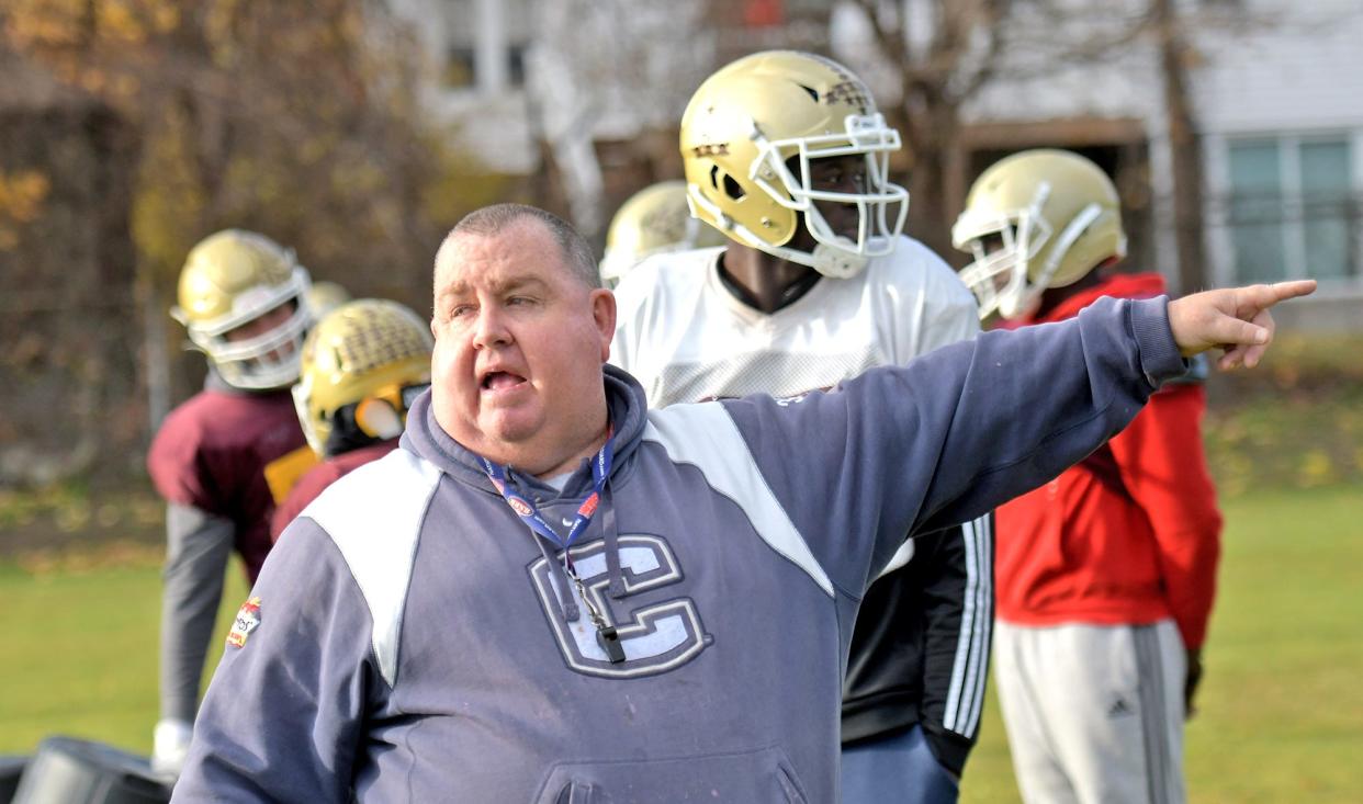 Doherty coach Sean Mulcahy describes a plan during practice at Foley Stadium.