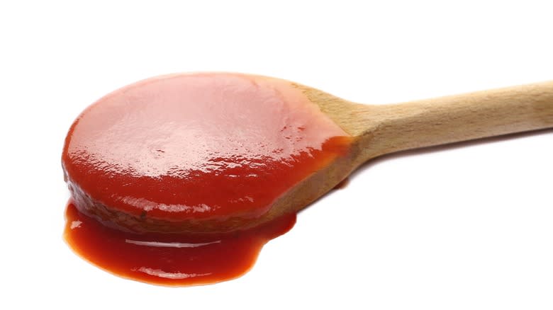 tomato ketchup on wooden spoon