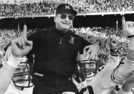 Michigan coach Bo Schembechler is carried from the field on Nov. 22, 1986 after a 26-24 victory over Ohio State in Columbus, Ohio for the Big Ten title and a trip to the Rose Bowl on New Year's Day.