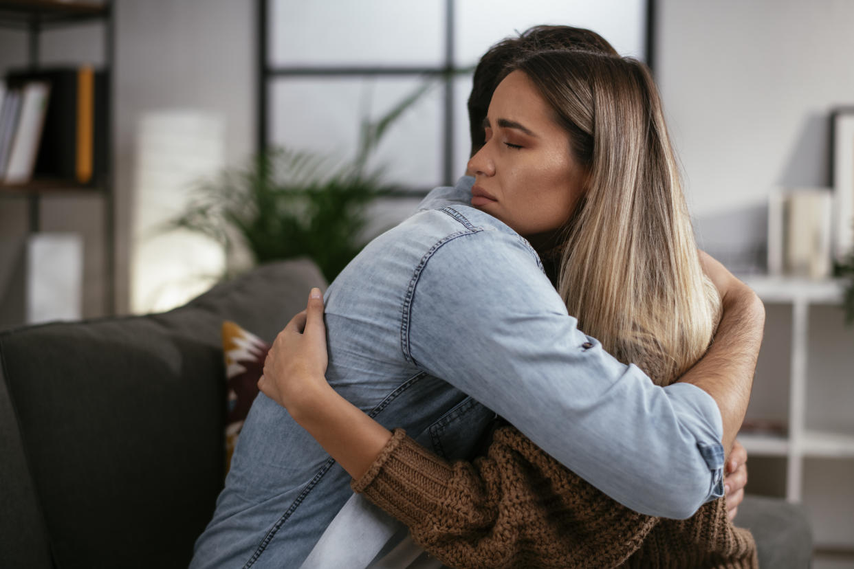 Young man having a problem. Girlfriend comforting her sad boyfriend.