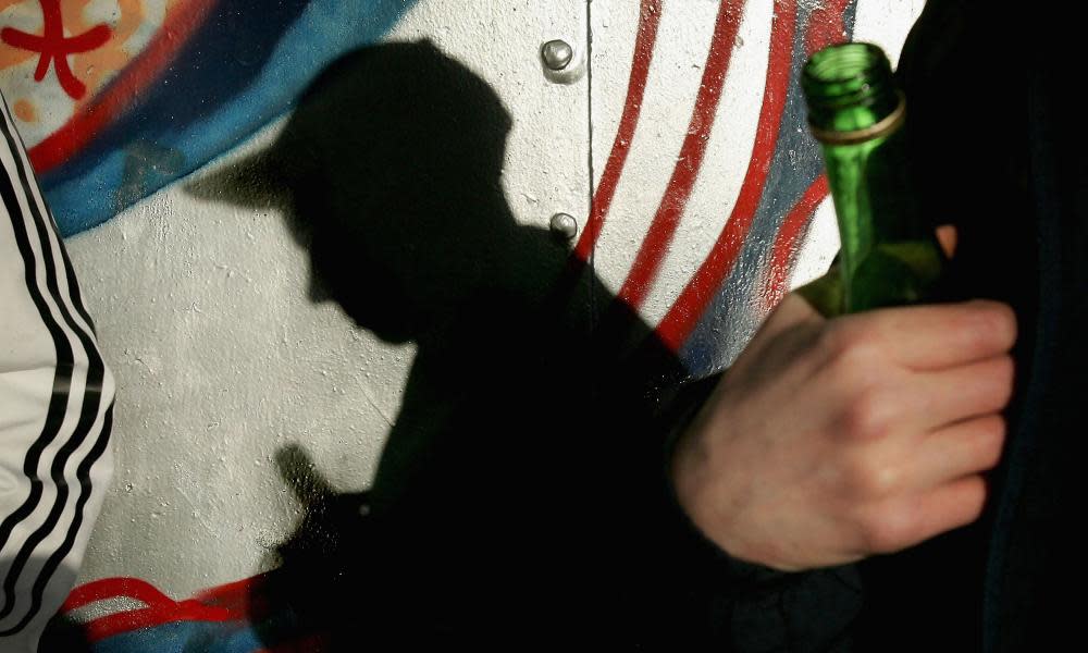 Silhouette of a young boy drinking from a bottle