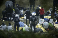 Activists are surrounded by police on the Garzweiler power plant grounds in Grevenbroich, western Germany, Saturday, Sept. 26, 2020. Anti-coal protesters have entered a mine to protest the continued extraction and use of fossil fuels. (David Young/dpa via AP)