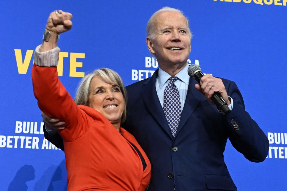 New Mexico Governor Michelle Lujan Grisham (L) gestures next to US President Joe Biden during a rally hosted by the Democratic Party of New Mexico at Ted M. Gallegos Community Center in Albuquerque, New Mexico, on November 3, 2022.