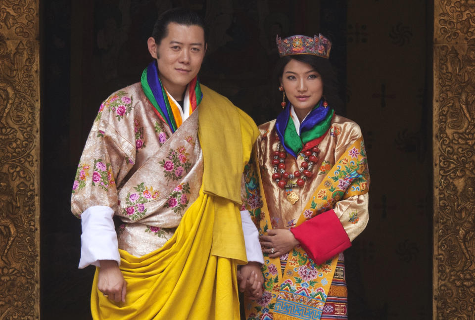 King Jigme Khesar Namgyel Wangchuck and Queen Jetsun Pema pose for pictures after their marriage at the Punkaha Dzong in Bhutan's ancient capital Punakha October 13, 2011. Bhutan's "Dragon King" married a commoner in a Himalayan monastic fortress on Thursday, sipping a chalice of ambrosia symbolizing eternal life, in a wedding that has transfixed a reclusive kingdom slowly embracing globalization.   REUTERS/Adrees Latif   (BHUTAN - Tags: ROYALS ENTERTAINMENT)