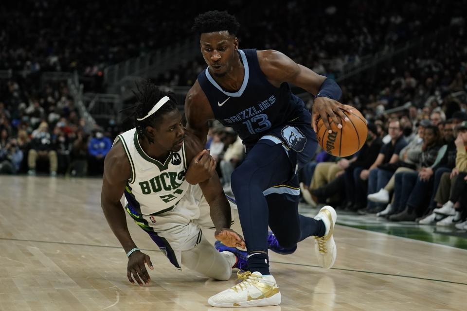 Memphis Grizzlies' Jaren Jackson Jr. tries to get past Milwaukee Bucks' Jrue Holiday during the second half of an NBA basketball game Wednesday, Jan. 19, 2022, in Milwaukee. (AP Photo/Morry Gash)