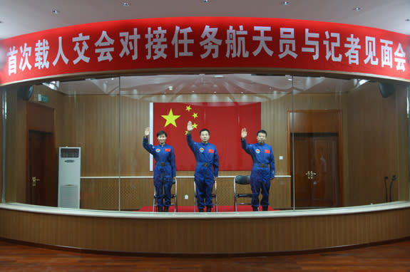 The crew of China's Shenzhou-9 mission, set to launch in June 2012, waves. L to R, Liu Yang (China's first female astronaut), Liu Wang, Jing Haipeng.