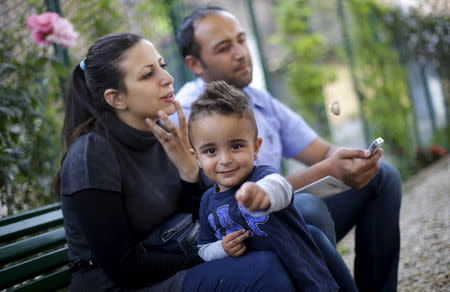 Syrian couple Hassan Zaheda, 31, and Nour Essa (L), 30, and their son Riad, 2, talk during an interview with Reuters at the Sant'Egidio community in Rome, Italy, April 20, 2016. REUTERS/Max Rossi