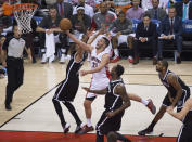 Toronto Raptors' Greivis Vasquez drives through the Brooklyn Nets defense during the first half of Game 1 of an opening-round NBA basketball playoff series, in Toronto on Saturday, April 19, 2014. (AP Photo/The Canadian Press, Darren Calabrese)